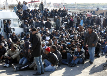 Illegal immigrants from North Africa arrive on the southern Italian island of Lampedusa February 13, 2011. More than 1,000 people escaping turmoil in Tunisia have landed on Lampedusa, a Sicilian island closer to Africa than mainland Italy, in rickety boats this week, raising fears of a new, uncontrolled wave of illegal immigration from North Africa.  
In two days 1,114 migrants arrived, including 113 on a large boat and nine Tunisians who were rescued from a small dinghy before it sank.

        REUTERS/Antonio Parinello (ITALY - Tags: POLITICS SOCIETY IMAGES OF THE DAY)