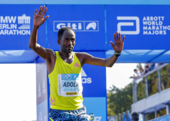 Ethiopia's Guye Adola celebrates after winning the Berlin Marathon in Berlin, Germany, Sunday, Sept. 26, 2021. (AP Photo/Lisa Leutner)