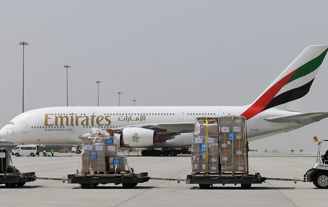(FILES) A file photo taken on March 02, 2020 shows medical equipment and coronavirus testing kits provided bt the World Health Organisation are pictured passing by an Emirates airlines Airbus A380-861, at the al-Maktum International airport in Dubai. - Dubai carrier Emirates Airline announced on March 22, 2020 it will suspend all passenger flights from March 25 amid the novel coronavirus outbreak. "Today we made the decision to temporarily suspend all passenger flights by 25 March 2020," the airline said on Twitter. The United Arab Emirates announced on Friday the first two deaths from the COVID-19 disease in the country. (Photo by KARIM SAHIB / AFP)