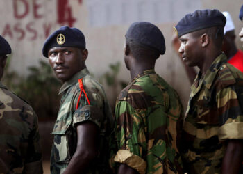Guinea-Bissau troops wait in queue to vote during elections in Bissau, Guinea-Bissau, on Sunday, June 19, 2005. Guinea-Bissau voted Sunday in the West African country's first presidential election since a 2003 coup, with 13 contenders vying for the top post _ including the man the military ousted two years ago. Many hope a new leadership can shunt one of the world's poorest nations toward democracy and development after decades of internal conflict.(AP Photo/Schalk van Zuydam)