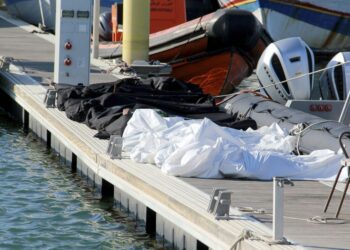 Covered dead bodies of migrants are pictured in the port of Sfax, central Tunisia, Thursday, Dec. 24, 2020. About 20 African migrants were found dead Thursday after their smuggling boat sank in the Mediterranean Sea while trying to reach Europe, Tunisian authorities said. Coast guard boats and local fishermen found and retrieved the bodies in the waters off the coastal city of Sfax in central Tunisia. (AP Photo/Houssem Zouari)/MEU111/20359645093895//2012241844