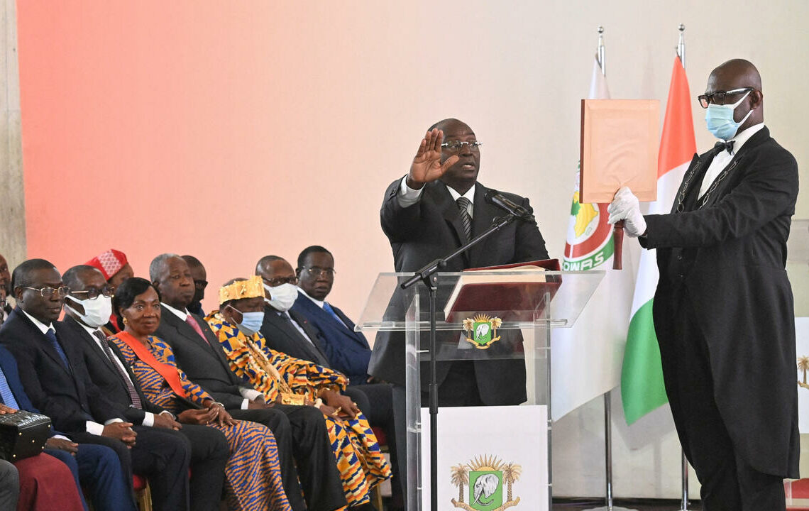 Ivorian vice president Tiemoko Meyliet Kone (2nd R) gestures while being sworn in at the presidential palace in Abidjan on April 20, 2022, a day after his appointment to this post that had been vacant for nearly two years. (Photo by Issouf SANOGO / AFP)